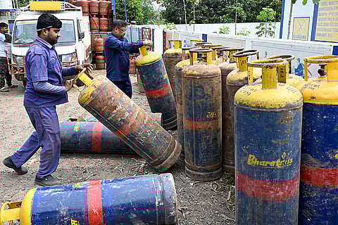 A worker arranges LPG cylinders at a gas agency amid the ongoing supply crunch, in Malda district, West Bengal.