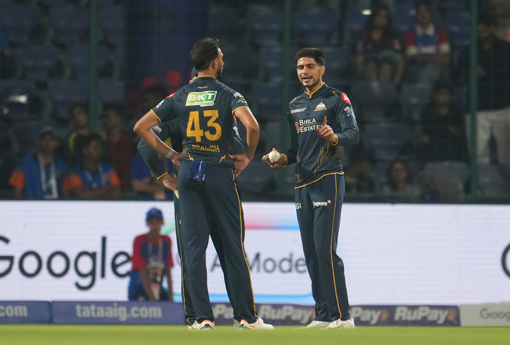 Gujarat Titans' captain Shubman Gill, right, talks to his team bowler Prasidh Krishna during the Indian Premier League cricket match between Delhi Capitals and Gujarat Titans in New Delhi.