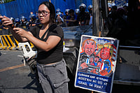 Aaron Favila : A protester stands beside a caricature of Israel Prime Minister Benjamin Netanyahu and U.S. President Donald Trump during a rally by transport workers and activists protesting the rise in oil prices on Friday, March 27, 2026, near the Malacanang presidential palace in Manila, Philippines.