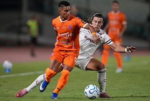 Jorge Gutierrez of Venezuela's Deportivo La Guaira, left, and Agustin Canobbio of Brazil's Fluminense fight for the ball during a Copa Libertadores Group C soccer match in Caracas, Venezuela.