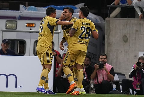 Leandro Paredes of Argentina's Boca Juniors, center, celebrates with teammates after scoring his side's opening goal against Chile's Universidad Catolica during a Copa Libertadores Group D soccer match in Santiago, Chile.