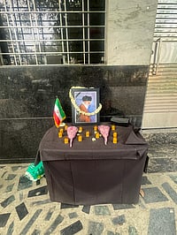 When Home Feels A World Away: Iranians in Delhi Face War From Afar Fozia Yasin : Outside the gates, a small table has been set up. On it rests a photograph of Ayatollah Ali Khamenei, framed by flowers.
