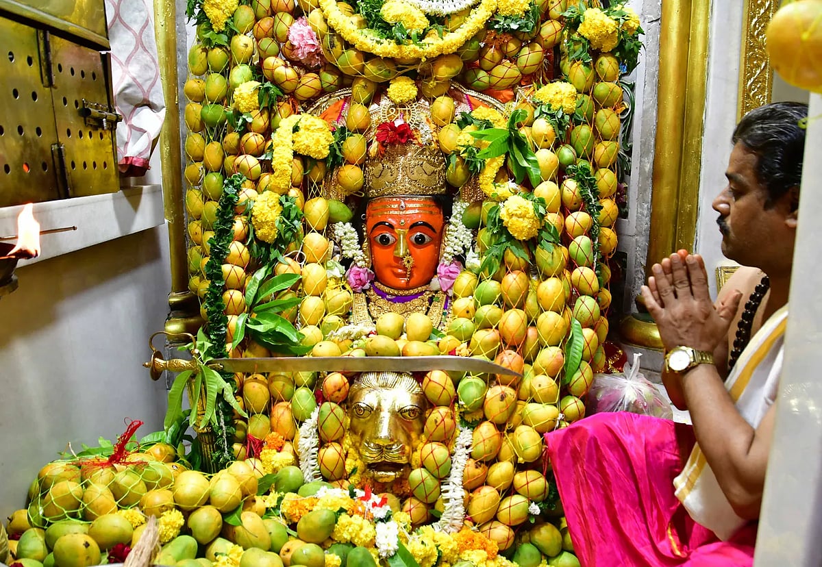 Devotee praying before a mango-decorated goddess idol on Akshaya Tritiya