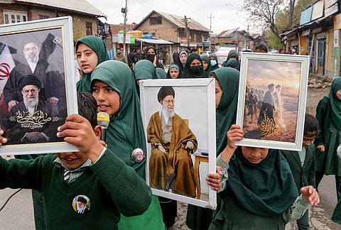 People raise slogans and hold a portrait of late Iran's Supreme Leader Ayatollah Ali Khamenei, in response to the ceasefire agreement between Iran, the United States and Israel, after US President Donald Trump pulled back from his threats to destroy Iranian civilization, in Srinagar, Jammu and Kashmir.