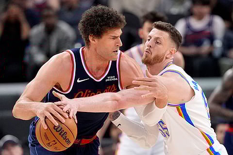 Oklahoma City Thunder center Isaiah Hartenstein, right, right, reaches in on Los Angeles Clippers center Brook Lopez during the first half of an NBA basketball game in Inglewood, Calif.