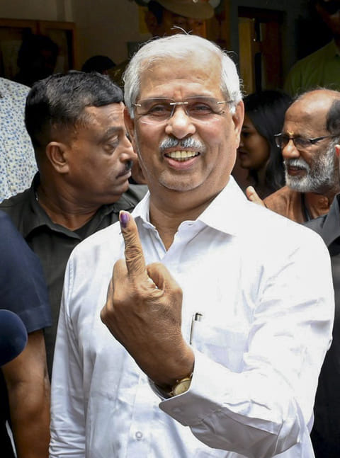 Kerala Governor Rajendra Vishwanath Arlekar shows his ink-marked finger after casting vote during the state Assembly elections, in Thiruvananthapuram. 