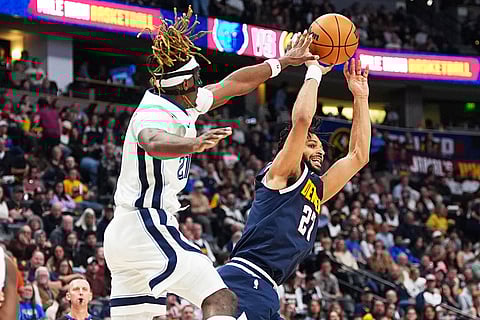 Denver Nuggets guard Jamal Murray, right, goes up for a basket as Memphis Grizzlies guard Jahmai Mashack defends in the second half of an NBA basketball game in Denver.