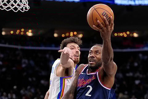 Los Angeles Clippers forward Kawhi Leonard, right, shoots as Oklahoma City Thunder center Chet Holmgren defends during the second half of an NBA basketball game in Inglewood, Calif. 
