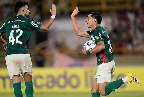 Ramon Sosa of Brazil's Palmeiras, right, celebrates scoring his side's first goal against Colombia's Junior with teammate Flaco Lopez during a Copa Libertadores Group F soccer match in Cartagena, Colombia.