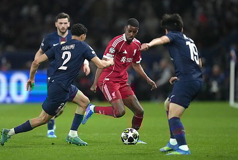 Liverpool's Alexander Isak, center, challenges for the ball with PSG's Achraf Hakimi, left, and PSG's Lee Kang-in during the Champions League quarterfinal first leg soccer match between Paris Saint-Germain and Liverpool in Paris.