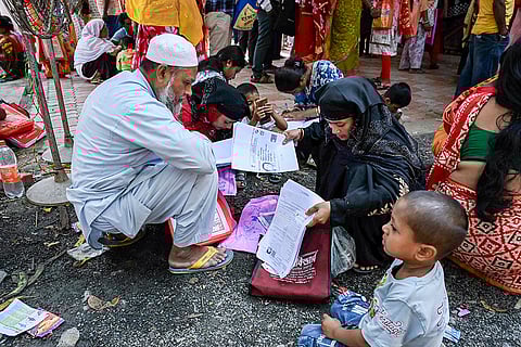 People wait to submit petitions before the Special Tribunal after their names were deleted from the Special Intensive Revision final voter list ahead of the West Bengal Assembly elections, in Nadia, West Bengal.
