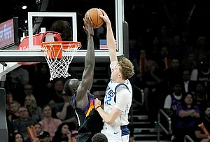 | Photo: AP/Ross D. Franklin : Dallas Mavericks forward Cooper Flagg (32) has his shot blocked by Phoenix Suns center Khaman Maluach, left, during the second half of an NBA basketball game in Phoenix.