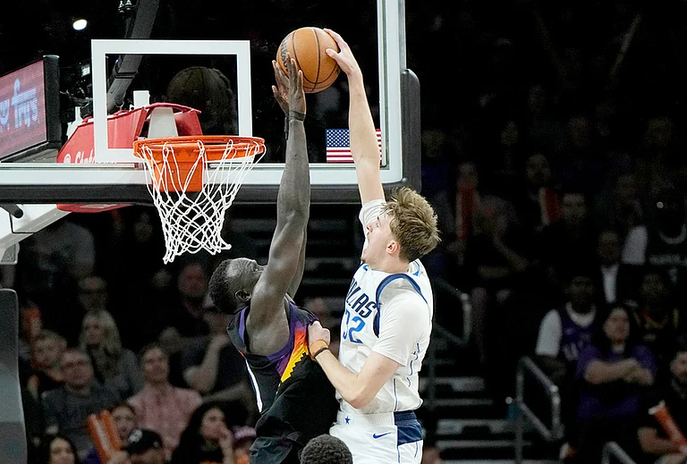 Dallas Mavericks forward Cooper Flagg (32) has his shot blocked by Phoenix Suns center Khaman Maluach, left, during the second half of an NBA basketball game in Phoenix. - | Photo: AP/Ross D. Franklin