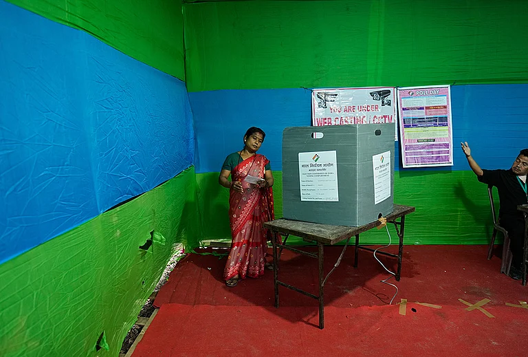 A polling official, right, instructs a woman to leave after she cast her vote at a polling center during the Assam state election in Guwahati | Rep Image | - | Photo: AP/Anupam Nath