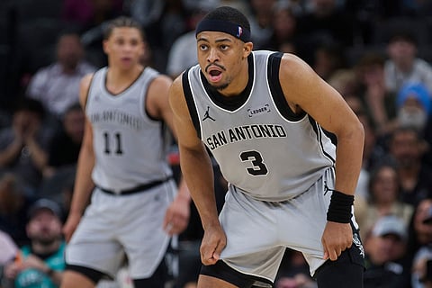 San Antonio Spurs forward Keldon Johnson (3) watches play during the second half of an NBA basketball game against the Portland Trail Blazers in San Antonio.