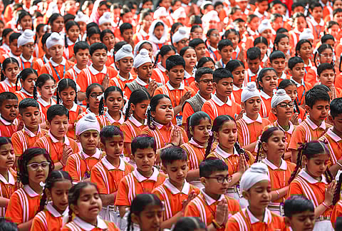 School students offer a special prayer with the message "No War, Restore Peace in the World" amid the ongoing West Asia conflict, in Jammu.