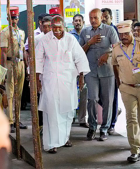Puducherry Chief Minister N Rangasamy, in white, leaves after casting vote during the Puducherry Assembly elections, at a polling station in Puducherry.