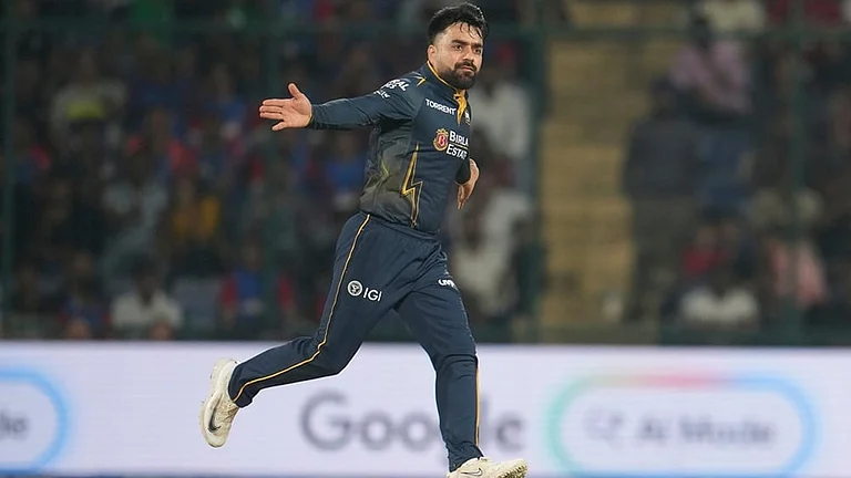 Gujarat Titans' Rashid Khan celebrates the wicket of Delhi Capitals' Nitish Rana during the Indian Premier League cricket match between Delhi Capitals and Gujarat Titans in New Delhi. - | Photo: AP/Manish Swarup