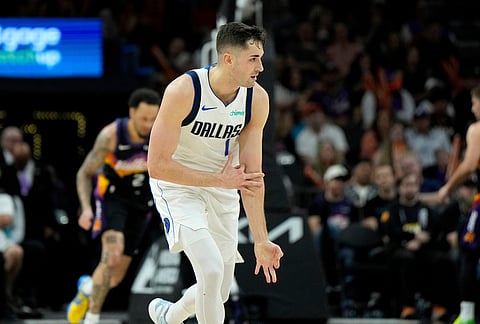 Dallas Mavericks guard John Poulakidas celebrates his 3-pointer against the Phoenix Suns during the second half of an NBA basketball game, in Phoenix.