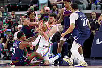 | Photo: AP/Mark J. Terrill : Oklahoma City Thunder center Chet Holmgren, center, battles for a loose ball with Los Angeles Clippers guard Bennedict Mathurin, left, and guard Tyty Washington Jr., second from left, as guard Cam Christie, second from right, and guard Jordan Miller watch during the second half of an NBA basketball game  in Inglewood, Calif.