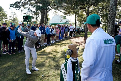 Rory McIlroy, of Northern Ireland, hits from the trees on the 18th hole during a practice round ahead of the Masters golf tournament at the Augusta National Golf Club in Augusta, Georgia.
