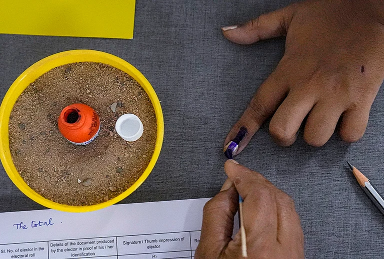 A voter gets her finger marked with indelible ink while casting vote during the Puducherry Assembly elections, at a polling station in Puducherry. - | Photo: PTI/R Senthilkumar