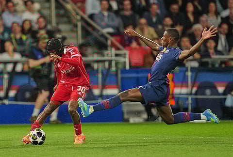 PSG's Nuno Mendes, right, challenges Liverpool's Jeremie Frimpong during the Champions League quarterfinal first leg soccer match between Paris Saint-Germain and Liverpool in Paris.