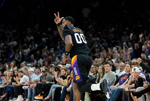 Phoenix Suns forward Royce O'Neale celebrates his 3-pointer against the Dallas Mavericks during the first half of an NBA basketball game, in Phoenix.