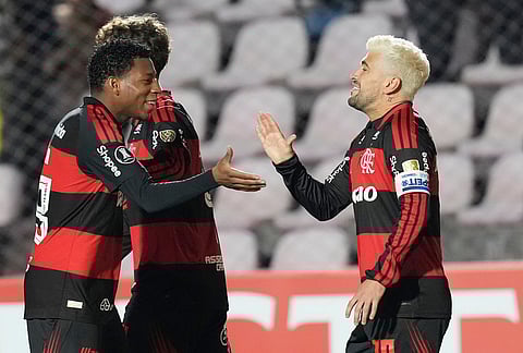 Giorgian De Arrascaeta of Brazil's Flamengo, right, celebrates with teammate Gonzalo Plata of Brazil's Flamengo after scoring his side's second goal against Peru's Cusco FC during a Copa Libertadores Group A soccer match in Cuzco, Peru.