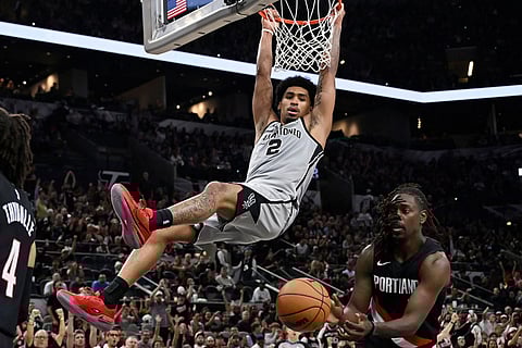 San Antonio Spurs guard Dylan Harper (2) dunks during the second half of an NBA basketball game against the Portland Trail Blazers in San Antonio.