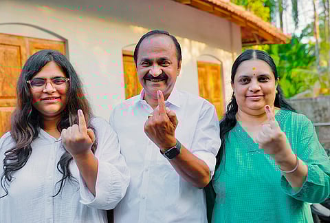 Leader of Opposition in the Kerala Assembly V D Satheesan, his wife Lakshmipriya and daughter Unnimaya show their ink-marked fingers after casting votes during the state Assembly elections, in Ernakulam district.