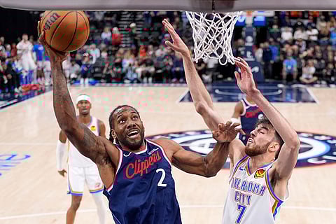 Los Angeles Clippers forward Kawhi Leonard, left, shoots as Oklahoma City Thunder center Chet Holmgren defends during the first half of an NBA basketball game in Inglewood, Calif.