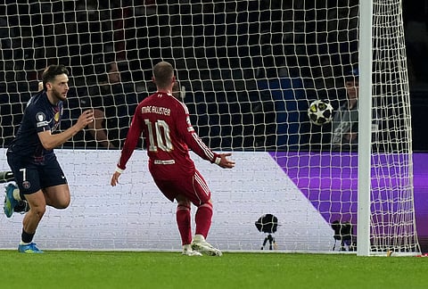 PSG's Khvicha Kvaratskhelia, left, celebrates after scoring his side's second goal during the Champions League quarterfinal first leg soccer match between Paris Saint-Germain and Liverpool in Paris.