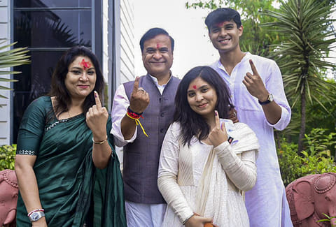 Assam Chief Minister Himanta Biswa Sarma and his family members show their ink-marked fingers after casting votes at Jalukbari constituency during the state Assembly elections, in Kamrup district. 