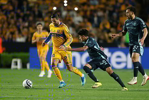Andre-Pierre Gignac of Mexico's Tigres, left, is followed by Peter Kingston, center, and Hassani Dotson of the United States' Seattle Sounders during a CONCACAF Champions Cup quarterfinal first leg soccer match in Monterrey, Mexico.