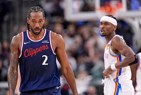 Oklahoma City Thunder guard Shai Gilgeous-Alexander, right, appears to say something to Los Angeles Clippers forward Kawhi Leonard after he scored while Leonard was defending during the second half of an NBA basketball game in Inglewood, California.