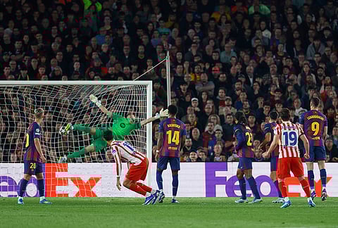 Atletico Madrid's Julian Alvarez, second right, scores his side's opening goal during the Champions League quarterfinal first leg soccer match between Barcelona and Atletico Madrid in Barcelona, Spain.