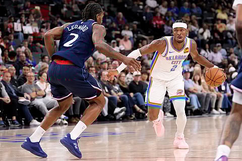 Oklahoma City Thunder guard Shai Gilgeous-Alexander, right, tries to get past Los Angeles Clippers forward Kawhi Leonard during the first half of an NBA basketball game in Inglewood, Calif.
