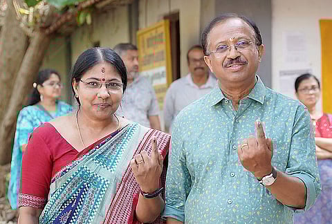 BJP leader and NDA candidate from Kazhakkootam constituency V Muraleedharan and others show their ink-marked fingers after casting votes during the Kerala Assembly elections, in Thiruvananthapuram. 