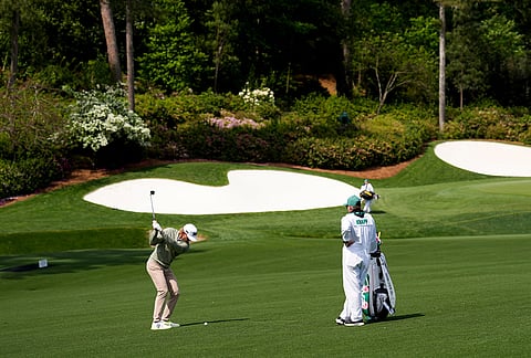 Jake Knapp hits from the fairway on the 13th hole during a practice round ahead of the Masters golf tournament at the Augusta National Golf Club in Augusta, Georgia.