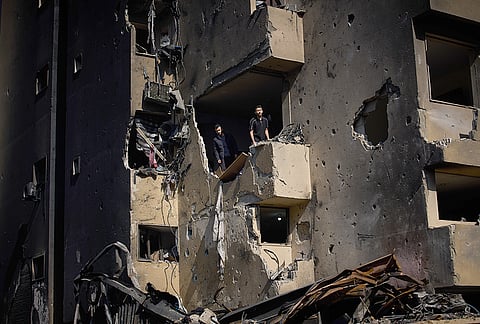 Men inspect the damage to their home destroyed in an Israeli airstrike a day earlier in Beirut, Lebanon, Thursday, April 9, 2026. 