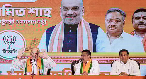 Union Home Minister Amit Shah addresses a press conference during the unveiling of 'BJP Sankalp Patra', the party's manifesto for the upcoming West Bengal Assembly elections, in Kolkata. Union Minister Sukanta Majumdar, right, and Leader of Opposition in the state Assembly Suvendu Adhikari are also seen. 