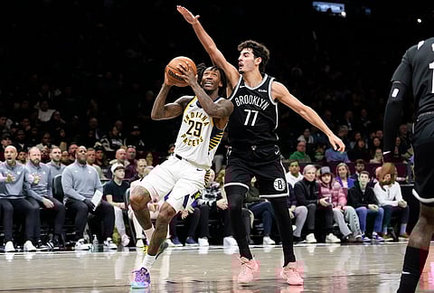 Indiana Pacers guard Quenton Jackson (29) attempts to shoot over Brooklyn Nets guard Ben Saraf (77) during the first half of an NBA basketball game, in New York. 