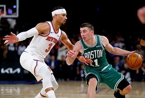 New York Knicks guard Josh Hart, left, defends against Boston Celtics guard Payton Pritchard during the second half of an NBA basketball game in New York.