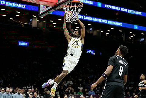 Indiana Pacers guard Quenton Jackson (29) dunks during the first half of an NBA basketball game against Brooklyn Nets, in New York. 