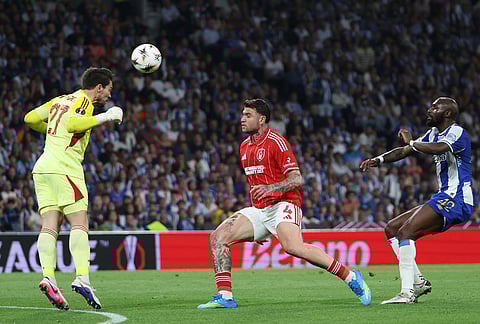 Nottingham Forest's goalkeeper Stefan Ortega heads the ball away in front of Nottingham Forest's Morato and Porto's Seko Fofana, right, during the Europa League quarterfinals, first leg, soccer match between FC Porto and Nottingham Forest in Porto, Portugal.