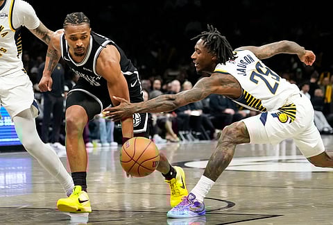 Indiana Pacers guard Quenton Jackson (29) blocks Brooklyn Nets guard Tyson Etienne, second from right, during the second half of an NBA basketball game, in New York. 