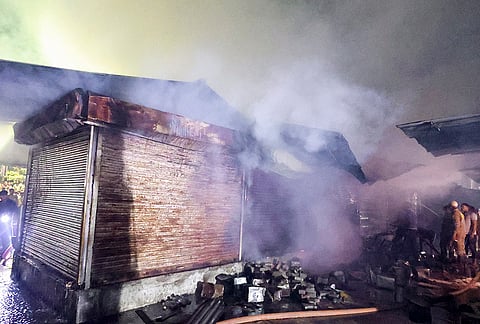 Firemen douse a fire at a fruit and vegetable market at Krishna Nagar area, in Lucknow, Uttar Pradesh.