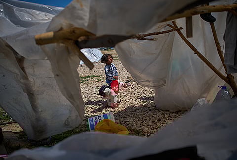 Ali, 4, holds a toy horse next to the tent his family uses as a shelter after fleeing Israeli bombardment in southern Lebanon, in Beirut, Lebanon, Wednesday, April 8, 2026.