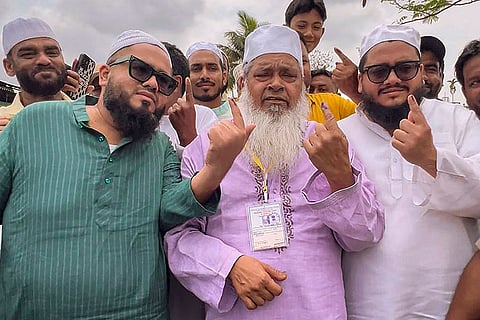 All India United Democratic Front (AIUDF) president and candidate from Binnakandi constituency, Maulana Badruddin Ajmal, shows his ink-marked finger after casting a vote in the Assam Assembly elections, in Binnakandi.